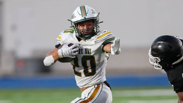Savannah Country Day running back Hyers Holland readies to throw a stiff arm to Windsor Forest's Marquis Lonnon during the season opener on Thursday, August 17, 2023 at Savannah High Stadium.