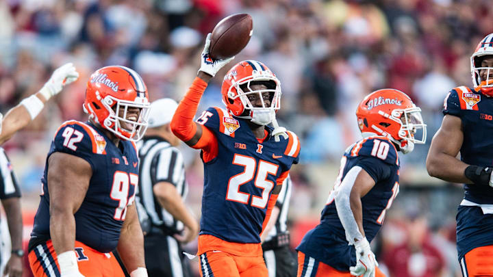 Dec 31, 2024; Orlando, FL, USA; Illinois Fighting Illini defensive back Jaheim Clarke (25) celebrates his fumble recovery against the South Carolina Gamecocks in the third quarter at Camping World Stadium. Mandatory Credit: Jeremy Reper-Imagn Images