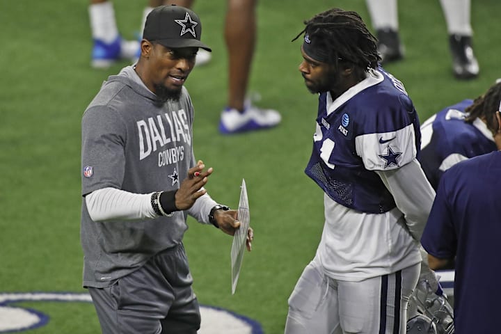 Dallas Cowboys player Trevon Diggs talks with Al Harris during training camp.