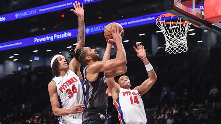 Brooklyn Nets forward Tosan Evbuomwan (12) looks to drive past Detroit Pistons forward Bobi Klintman (34) and guard Wendell Moore Jr. (14) in the fourth quarter at Barclays Center.