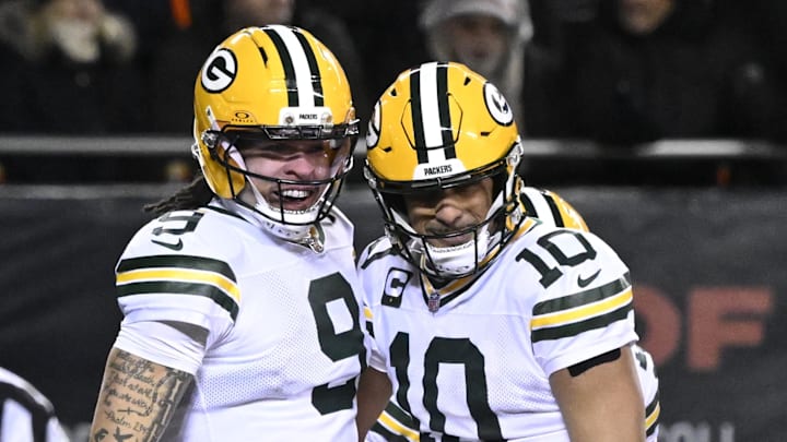 Green Bay Packers receiver Christian Watson (9) and quarterback Jordan Love celebrate a playoff touchdown at the Bears.