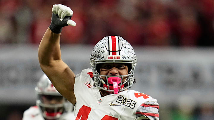 Ohio State Buckeyes defensive end JT Tuimoloau (44) celebrates tackling Notre Dame Fighting Irish quarterback Riley Leonard (13) during the College Football Playoff National Championship at Mercedes-Benz Stadium in Atlanta on January 20, 2025.