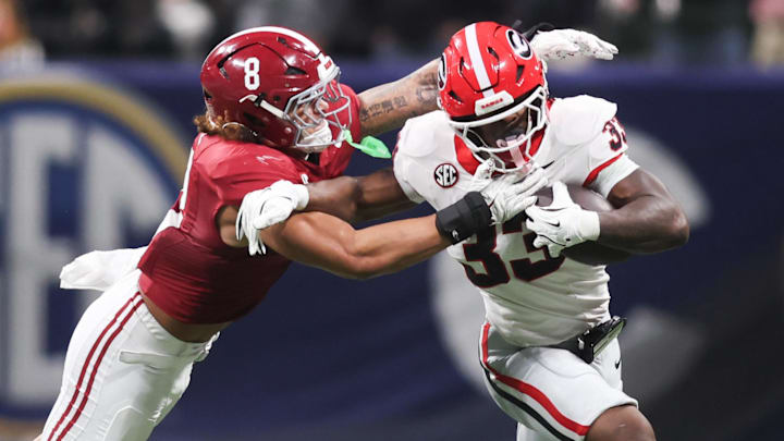 Dec 6, 2025; Atlanta, GA, USA; Georgia Bulldogs running back Chauncey Bowens (33) rushes as Alabama Crimson Tide linebacker Justin Hill (8) tackles during the second quarter during the 2025 SEC Championship game at Mercedes-Benz Stadium. Mandatory Credit: Brett Davis-Imagn Images
