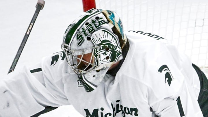 Michigan State's Trey Augustine deflects a Michigan shot during the second period on Friday, Dec. 5, 2025, at Munn Ice Arena in East Lansing.