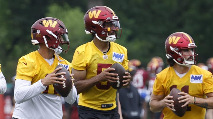 Jun 5, 2024; Ashburn, VA, USA; (L-R) Washington Commanders quarterback Jeff Driskel (16), Commanders quarterback Marcus Mariota (0), Commanders quarterback Jayden Daniels (5), and Commanders quarterback Sam Hartman (11) drop back to pass during an OTA workout at Commanders Park. Mandatory Credit: Geoff Burke-USA TODAY Sports