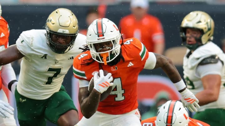 Sep 13, 2025; Miami Gardens, Florida, USA; Miami Hurricanes running back Mark Fletcher Jr. (4) runs with the football against the South Florida Bulls during the first quarter at Hard Rock Stadium. Mandatory Credit: Sam Navarro-Imagn Images