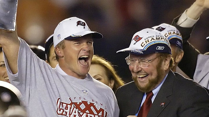 Tampa Bay Buccaneers head coach Jon Gruden raises the Vince Lombardi Trophy next to owner Malcolm Glazer.