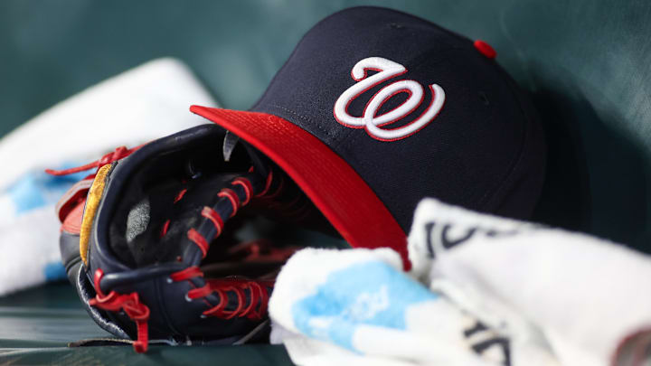 Dark blue Washington Nationals hat on top of a black mitt