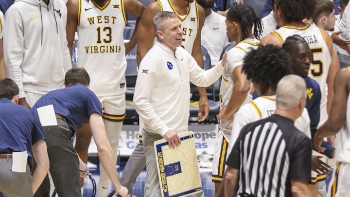 Jan 17, 2026; Morgantown, West Virginia, USA; West Virginia Mountaineers head coach Ross Hodge talks to his team during a timeout during the second half against the Colorado Buffaloes at Hope Coliseum. Jan 17, 2026; Morgantown, West Virginia, USA; West Virginia Mountaineers head coach Ross Hodge talks to his team during a timeout during the second half against the Colorado Buffaloes at Hope Coliseum.