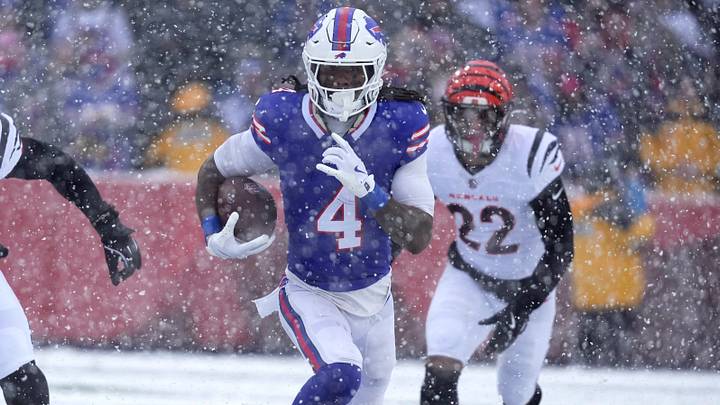 Buffalo Bills running back James Cook III carries the ball getting past Cincinnati Bengals running back Gary Brightwell and safety Geno Stone. Buffalo Bills running back James Cook III carries the ball getting past Cincinnati Bengals running back Gary Brightwell and safety Geno Stone.