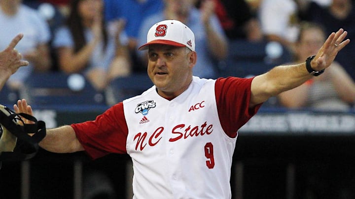 Jun 20, 2013; Omaha, NE, USA; North Carolina State Wolfpack head coach Elliot Turner (9) protests to the umpire that the runner was ruled safe at home against the North Carolina Tarheels during the College World Series game at TD Ameritrade Park. Mandatory Credit: Bruce Thorson-Imagn Images