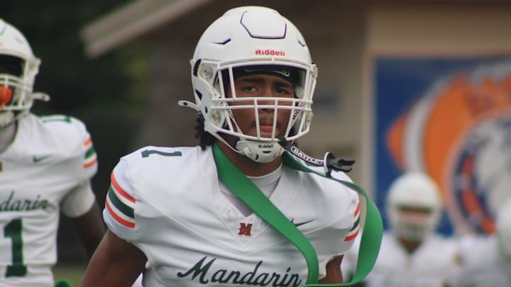 Mandarin wide receiver Brysen Wright (1) runs through pregame warm-ups before a high school spring football game at Bolles on May 22, 2025. [Clayton Freeman/Florida Times-Union]
