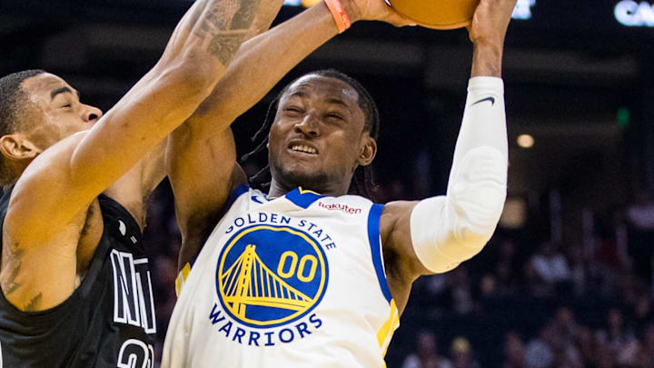 Jan 22, 2023; San Francisco, California, USA; Brooklyn Nets center Nic Claxton (33) fouls Golden State Warriors forward Jonathan Kuminga (00) during the first half at Chase Center. Mandatory Credit: John Hefti-Imagn Images