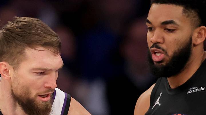 Sacramento Kings forward Domantas Sabonis controls the ball against New York Knicks center Karl-Anthony Towns.
