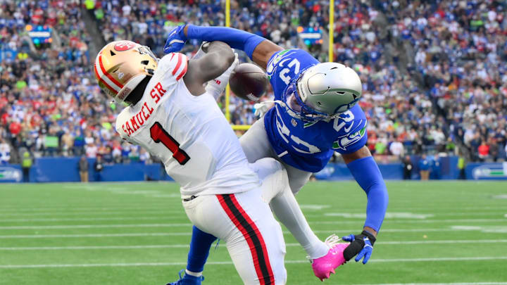 Oct 10, 2024; Seattle, Washington, USA; Seattle Seahawks cornerback Artie Burns (23) breaks up a pass intended for San Francisco 49ers wide receiver Deebo Samuel Sr. (1) during the first half at Lumen Field. Mandatory Credit: Steven Bisig-Imagn Images