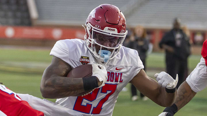 Jan 29, 2026; Mobile, AL, USA; American running back Mike Washington Jr (27) of Arkansas runs the ball during American Senior Bowl practice at Hancock Whitney Stadium. 