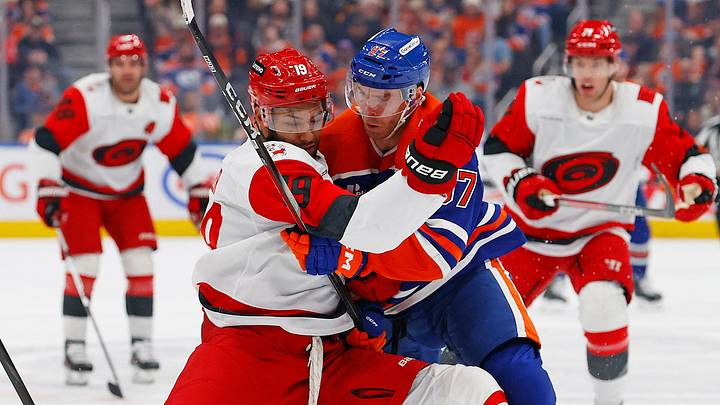 Mar 6, 2026; Edmonton, Alberta, CAN; Carolina Hurricanes defensemen K'Andre Miller (19) ties up Edmonton Oilers forward Connor McDavid (97) during the first period at Rogers Place. Mandatory Credit: Perry Nelson-Imagn Images