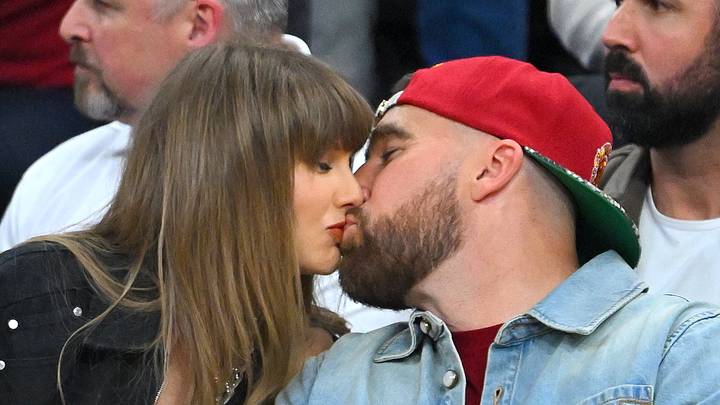 Taylor Swift and Travis Kelce kiss at the New York Knicks v Cleveland Cavaliers game
