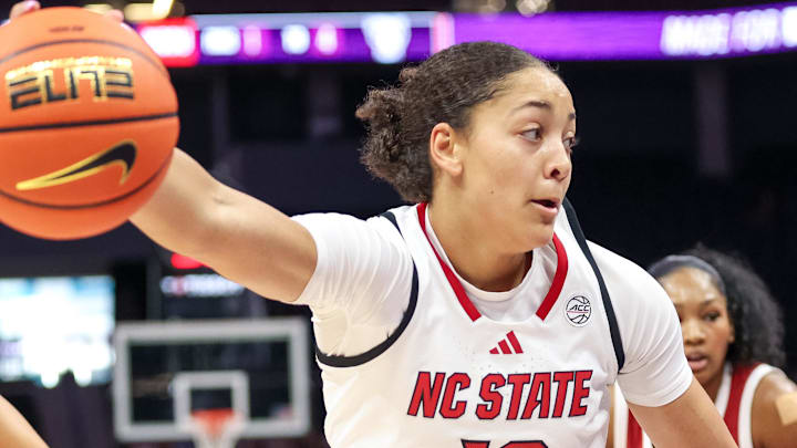 Nov 9, 2025; Charlotte, North Carolina, USA; NC State Wolfpack forward Khamil Pierre (12) controls the ball against the Southern California Trojans during the second quarter of the Ally Tipoff game at Spectrum Center. Mandatory Credit: Cory Knowlton-Imagn Images