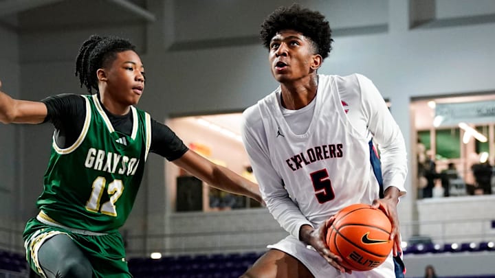 Columbus Explorers guard Jaxon Richardson (5) drives to the basket as Grayson Rams guard Blaze Johnson (12) guards him during the third quarter of a City of Palms Classic quarterfinal game at Suncoast Credit Union Arena in Fort Myers, Fla., on Friday, Dec. 20, 2024.