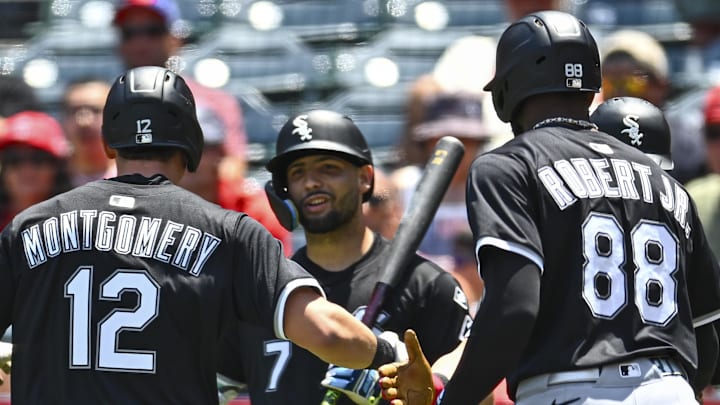 Chicago White Sox catcher Edgar Quero (7) celebrates with shortstop Colson Montgomery (12) and center fielder Luis Robert Jr. (88) after scoring a run against the Los Angeles Angels at Angel Stadium. 