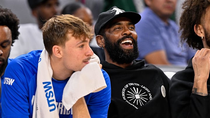 Oct 6, 2025; Fort Worth, Texas, USA; Dallas Mavericks forward Cooper Flagg (left) and guard Kyrie Irving (right) look on during the game between the Dallas Mavericks and the Oklahoma City Thunder at Dickie's Arena. Mandatory Credit: Jerome Miron-Imagn Images