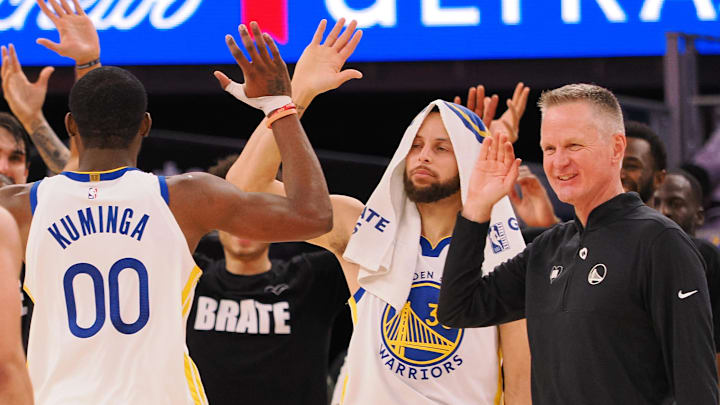 Jan 24, 2024; San Francisco, California, USA; Golden State Warriors forward Jonathan Kuminga (00) high fives guard Stephen Curry (30) and head coach Steve Kerr as a time out is called against the Atlanta Hawks during the fourth quarter at Chase Center. Mandatory Credit: Kelley L Cox-Imagn Images