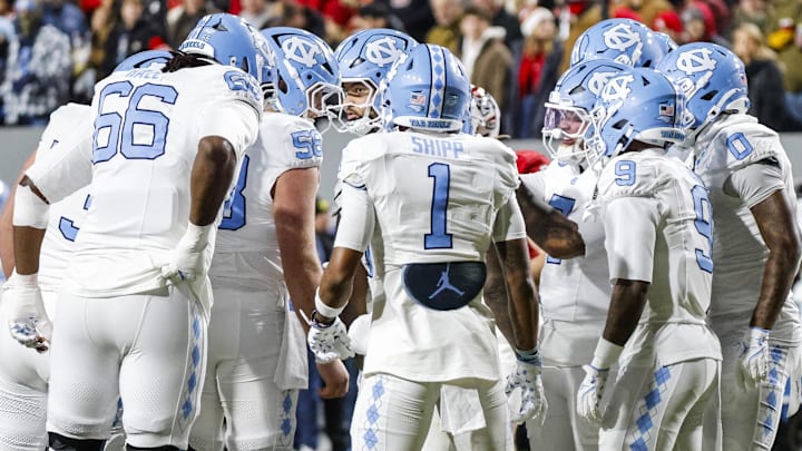 Nov 29, 2025; Raleigh, North Carolina, USA; North Carolina Tar Heels huddles during the first half of the game against NC State Wolfpack at Carter-Finley Stadium. Mandatory Credit: Jaylynn Nash-Imagn Images Nov 29, 2025; Raleigh, North Carolina, USA; North Carolina Tar Heels huddles during the first half of the game against NC State Wolfpack at Carter-Finley Stadium. Mandatory Credit: Jaylynn Nash-Imagn Images