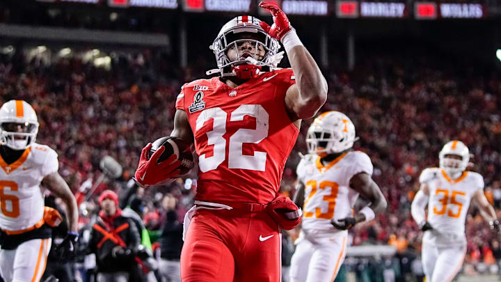 Ohio State Buckeyes running back TreVeyon Henderson (32) runs for a touchdown during the first half of the College Football Playoff first round game against the Tennessee Volunteers at Ohio Stadium in Columbus on Dec. 21, 2024. Ohio State Buckeyes running back TreVeyon Henderson (32) runs for a touchdown during the first half of the College Football Playoff first round game against the Tennessee Volunteers at Ohio Stadium in Columbus on Dec. 21, 2024.