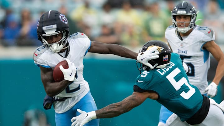 Dec 29, 2024; Jacksonville, Florida, USA; Tennessee Titans running back Tyjae Spears (2) runs the ball against Jacksonville Jaguars safety Andre Cisco (5) in the first quarter at EverBank Stadium. Mandatory Credit: Jeremy Reper-Imagn Images Dec 29, 2024; Jacksonville, Florida, USA; Tennessee Titans running back Tyjae Spears (2) runs the ball against Jacksonville Jaguars safety Andre Cisco (5) in the first quarter at EverBank Stadium. Mandatory Credit: Jeremy Reper-Imagn Images