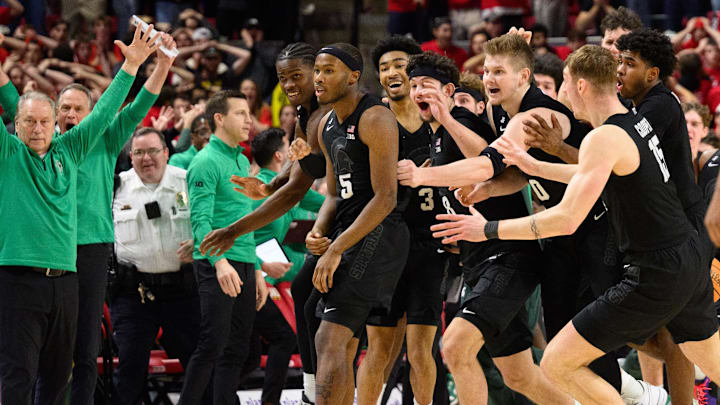 Michigan State players and coaches celebrate after a shot by Tre Holloman goes in at the buzzer Wednesday against Maryland.