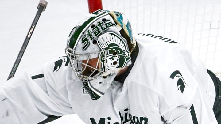 Michigan State's Trey Augustine deflects a Michigan shot during the second period on Friday, Dec. 5, 2025, at Munn Ice Arena in East Lansing. Michigan State's Trey Augustine deflects a Michigan shot during the second period on Friday, Dec. 5, 2025, at Munn Ice Arena in East Lansing.