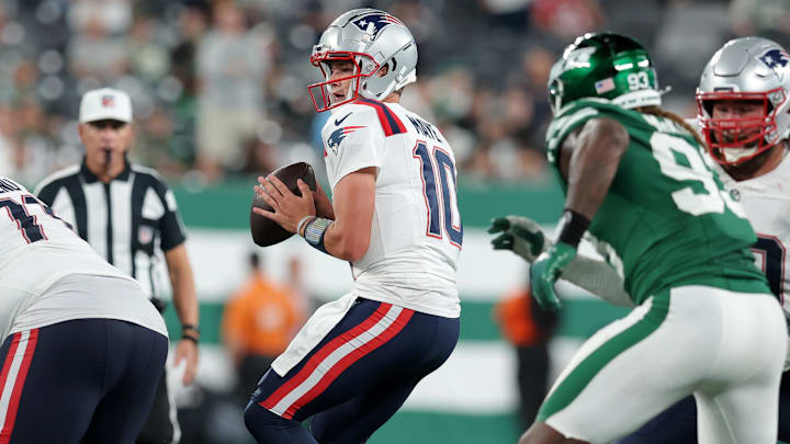 Sep 19, 2024; East Rutherford, New Jersey, USA; New England Patriots quarterback Drake Maye (10) looks to pass against the New York Jets during the fourth quarter at MetLife Stadium. Mandatory Credit: Brad Penner-Imagn Images
