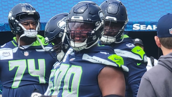 Seahawks guards Laken Tomlinson and McClendon Curtis listen for instructions prior to a drill during an OTA practice.