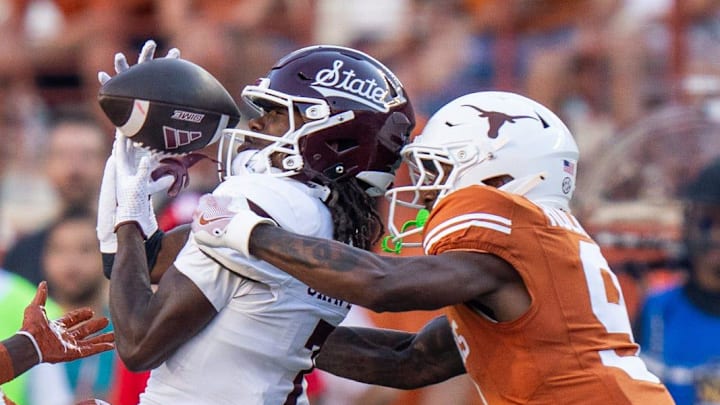 Texas Longhorns defensive back Andrew Mukuba (4) and Texas Longhorns defensive back Gavin Holmes (9) take down Mississippi State Bulldogs wide receiver Mario Craver (7) as the Texas Longhorns take on Mississippi State at Darrell K Royal-Texas Memorial Stadium in Austin Saturday, Sept. 28, 2024.