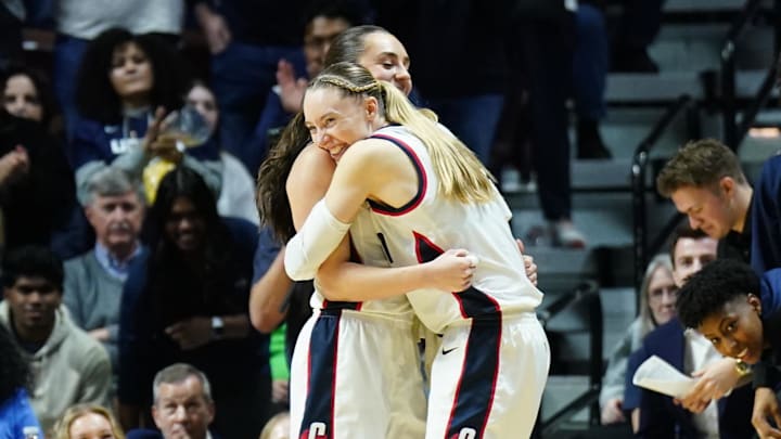 UConn Huskies guard Paige Bueckers hugs Nika Muhl late in the fourth quarter as they take on the Georgetown Hoyas.