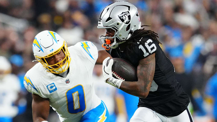 Sep 15, 2025; Paradise, Nevada, USA; Las Vegas Raiders wide receiver Jakobi Meyers (16) rushes as Los Angeles Chargers linebacker Daiyan Henley (0) defends at Allegiant Stadium. Mandatory Credit: Stephen R. Sylvanie-Imagn Images