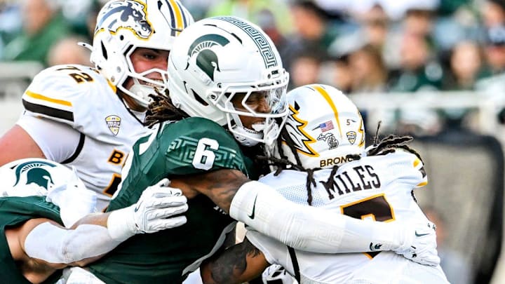Michigan State's Ade Willie, center, tackles Western Michigan's Devin Miles during the first quarter on Friday, Aug. 29, 2025, in East Lansing.