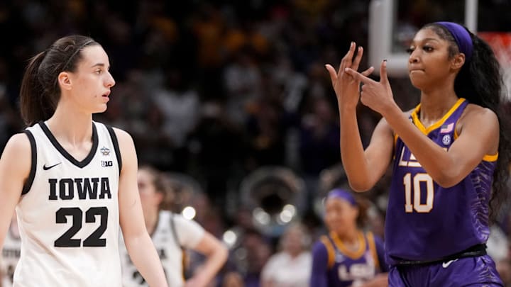 Angel Reese (10) shows Iowa Caitlin Clark her ring finger during the final seconds of the women's 2023 NCAA Tournament national championship game.