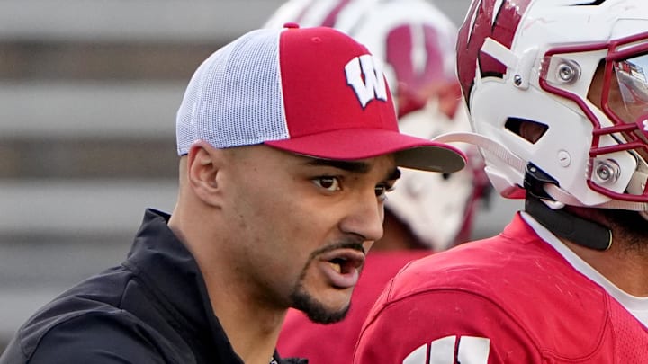 Apr 11, 2023; Madison, WI, USA; Wisconsin running backs coach Devon Spalding talks with running back Chez Mellusi (1) during practice Tuesday, April 11, 2023 at Camp Randall Stadium in Madison, Wis. Mandatory Credit: Mark Hoffman-Imagn Images