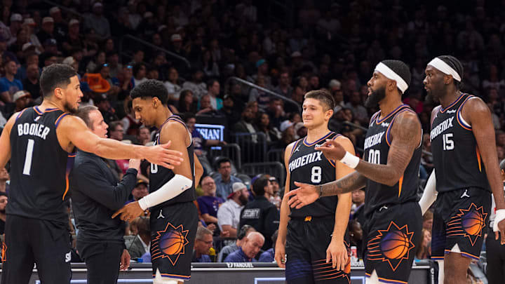 Nov 2, 2025; Phoenix, Arizona, USA; Phoenix Suns guard Devin Booker (1), forward Ryan Dunn (0), Coach Jordan Ott, guard Grayson Allen (8), forward Royce O'Neale (00) and center Mark Williams (15) celebrate during a time-out in the second half against the San Antonio Spurs at Mortgage Matchup Center. Mandatory Credit: Allan Henry-Imagn Images