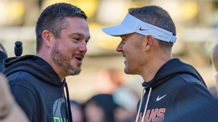 Oregon head coach Dan Lanning, left, and USC head coach Lincoln Riley shake hands before the game as the Oregon Ducks host the USC Trojans on Nov. 22, 2025, at Autzen Stadium in Eugene, Oregon.