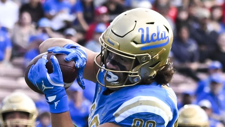 Nov 30, 2024; Pasadena, California, USA; UCLA Bruins tight end Moliki Matavao (88) catches a pass against Fresno State Bulldogs defensive back Jakari Embry (17) during the first quarter at Rose Bowl. Mandatory Credit: Robert Hanashiro-Imagn Images