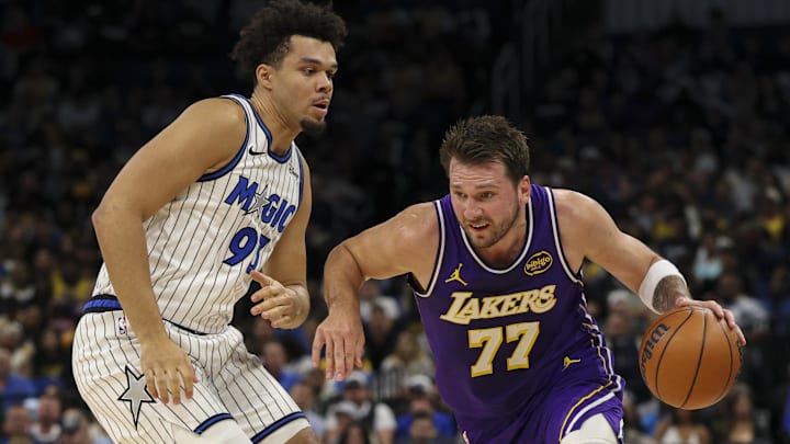 Mar 21, 2026; Orlando, Florida, USA; Los Angeles Lakers guard Luka Doncic (77) drives to the basket past Orlando Magic forward Noah Penda (93) in the first quarter at Kia Center. Mandatory Credit: Nathan Ray Seebeck-Imagn Images Mar 21, 2026; Orlando, Florida, USA; Los Angeles Lakers guard Luka Doncic (77) drives to the basket past Orlando Magic forward Noah Penda (93) in the first quarter at Kia Center. Mandatory Credit: Nathan Ray Seebeck-Imagn Images