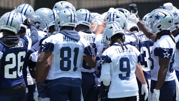 Dallas Cowboys players huddle during training camp at the River Ridge Fields.