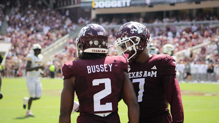 Oct 5, 2024; College Station, Texas, USA; Texas A&M Aggies' Terry Bussey (2) and Moose Muhammad III (7) talk on the field against the Missouri Tigers at Kyle Field. 