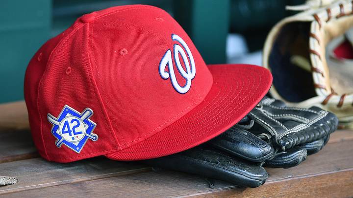 Red Washington Nationals hat on top of a black mitt Red Washington Nationals hat on top of a black mitt