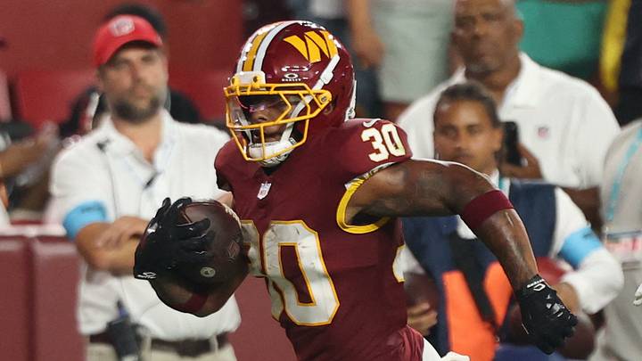 Aug 14, 2026; Landover, Maryland, USA; Washington Commanders running back Robert Henry Jr. (30) carries the ball past Miami Dolphins cornerback Marco Wilson (21) en route to a touchdown during the first half at Northwest Stadium. Mandatory Credit: Geoff Burke-Imagn Images Aug 14, 2026; Landover, Maryland, USA; Washington Commanders running back Robert Henry Jr. (30) carries the ball past Miami Dolphins cornerback Marco Wilson (21) en route to a touchdown during the first half at Northwest Stadium. Mandatory Credit: Geoff Burke-Imagn Images
