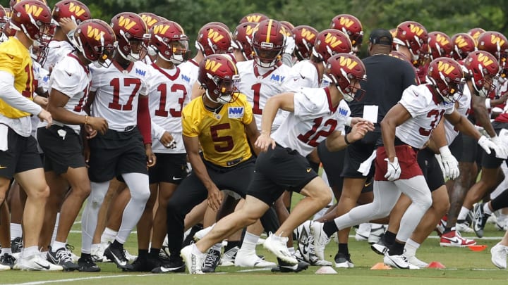 Jun 5, 2024; Ashburn, VA, USA; Washington Commanders players run the field during OTA workouts at  Commanders Park. Mandatory Credit: Geoff Burke-USA TODAY Sports