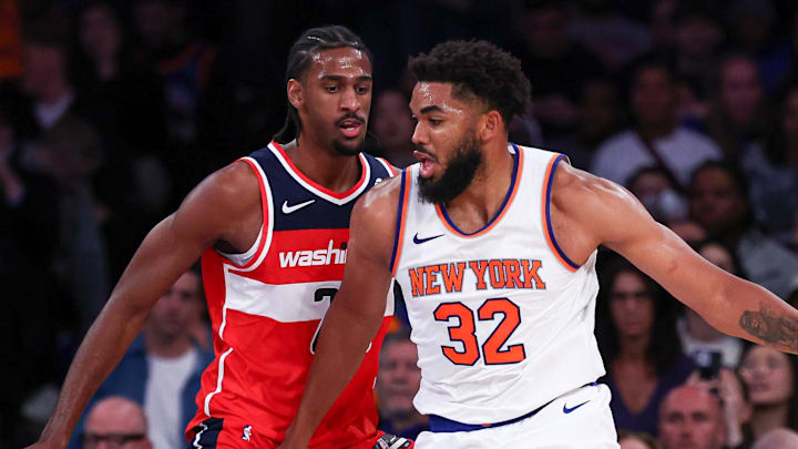 Oct 9, 2024; New York, New York, USA; New York Knicks center Karl-Anthony Towns (32) dribbles against Washington Wizards forward Alex Sarr (20) during the first half at Madison Square Garden. Mandatory Credit: Vincent Carchietta-Imagn Images